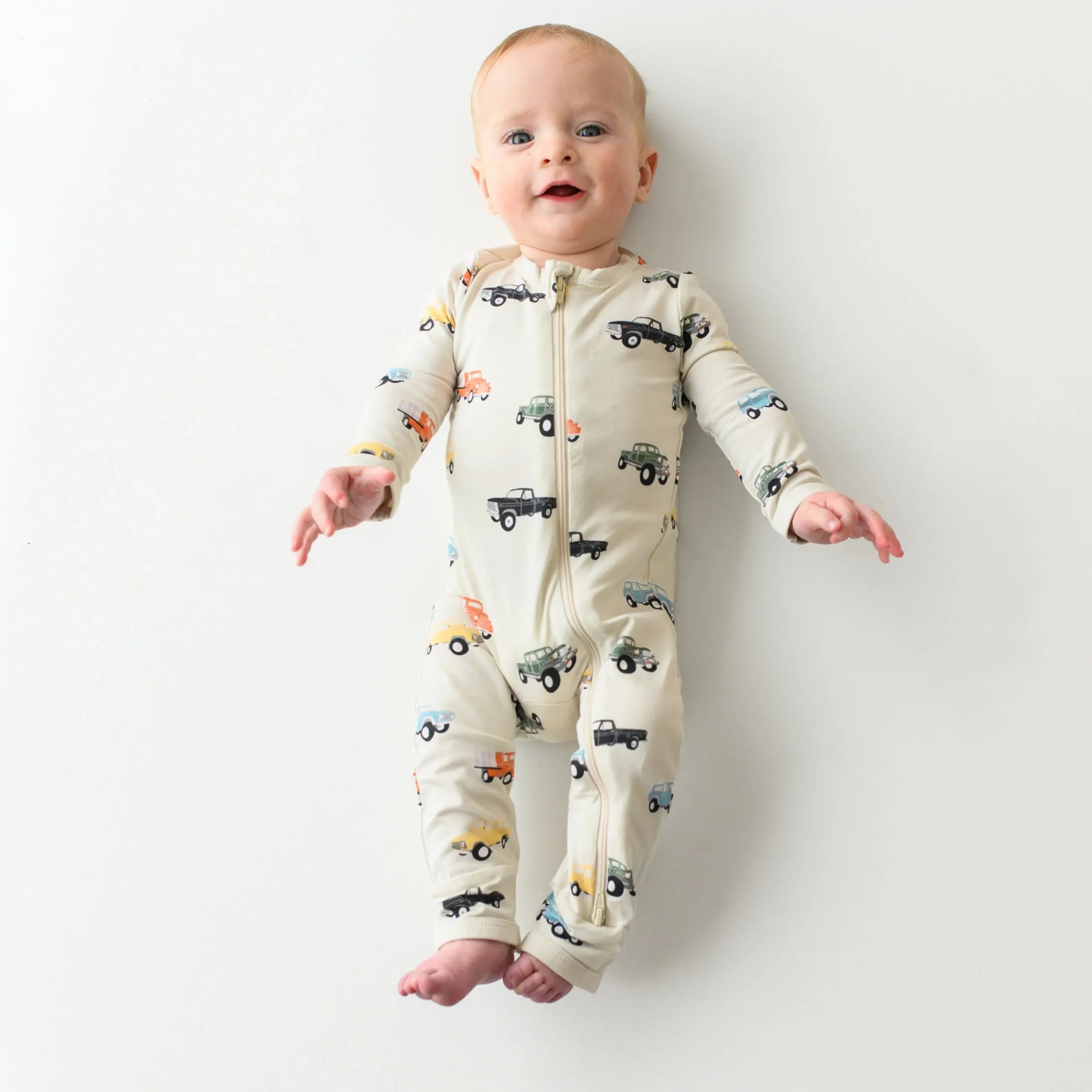 Sale Kyte Baby Zippered Romper in Vintage Truck